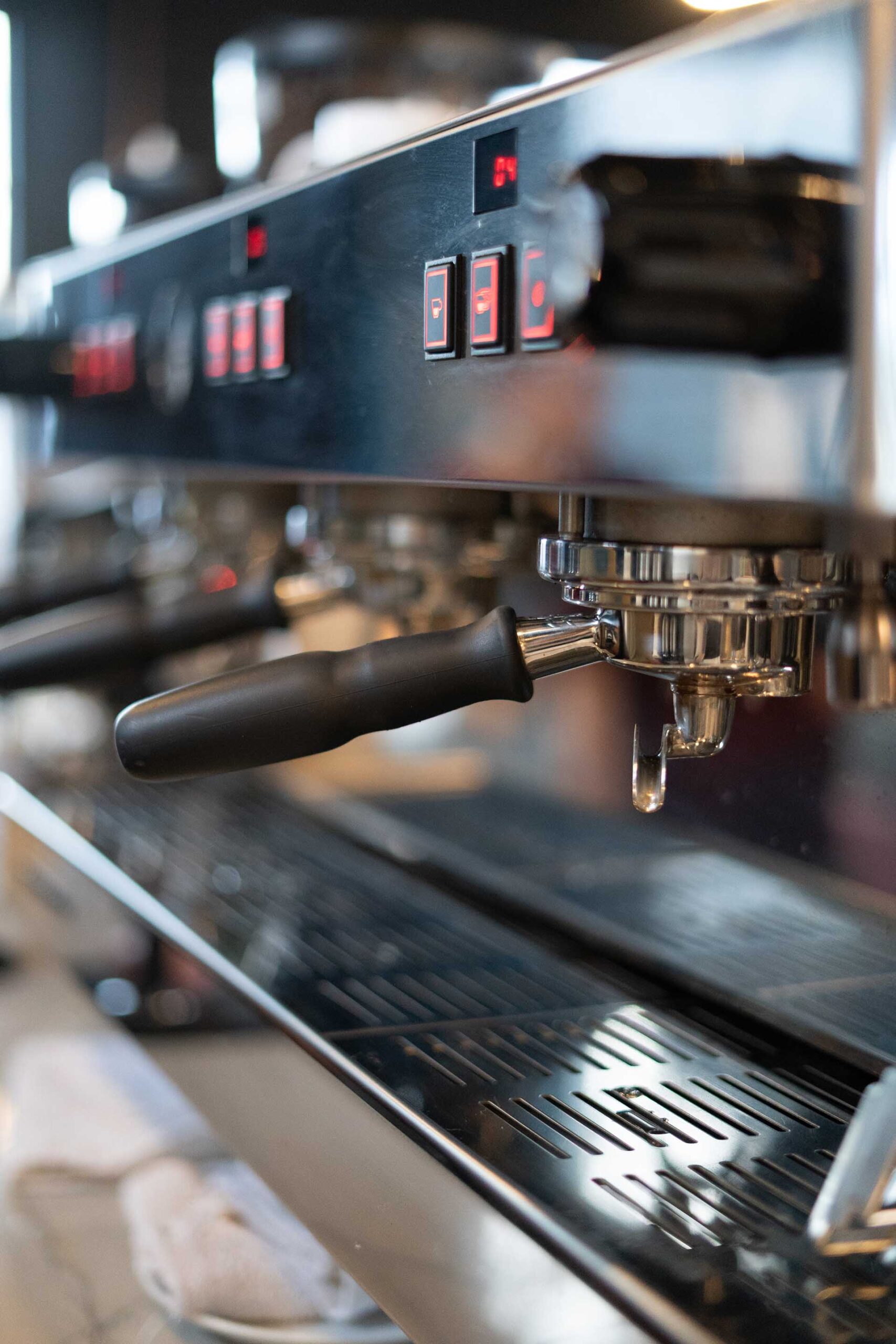 Professional espresso setup in bustling Prescott AZ coffee shop Self-serve tap wall at City Tavern with digital beer menus and wooden-handled taps